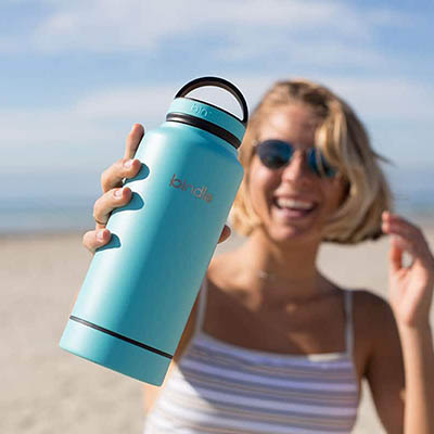 woman-holding-water-bottle-on-beach-res-mob