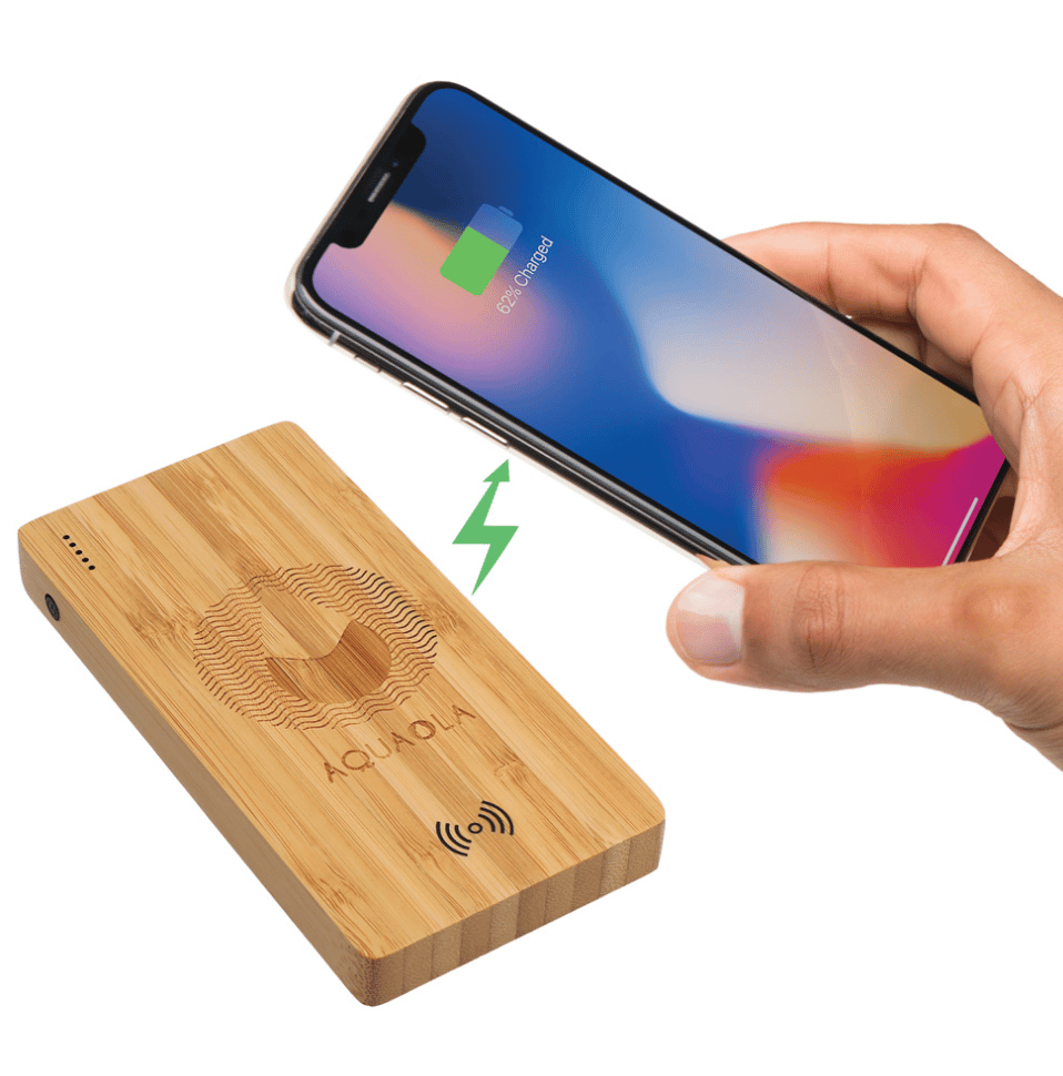 A corporate branded rectangular Bamboo Wireless Power Bank with an iPhone being held over it and a green lightening bolt to simulate the phone being charged wireless.