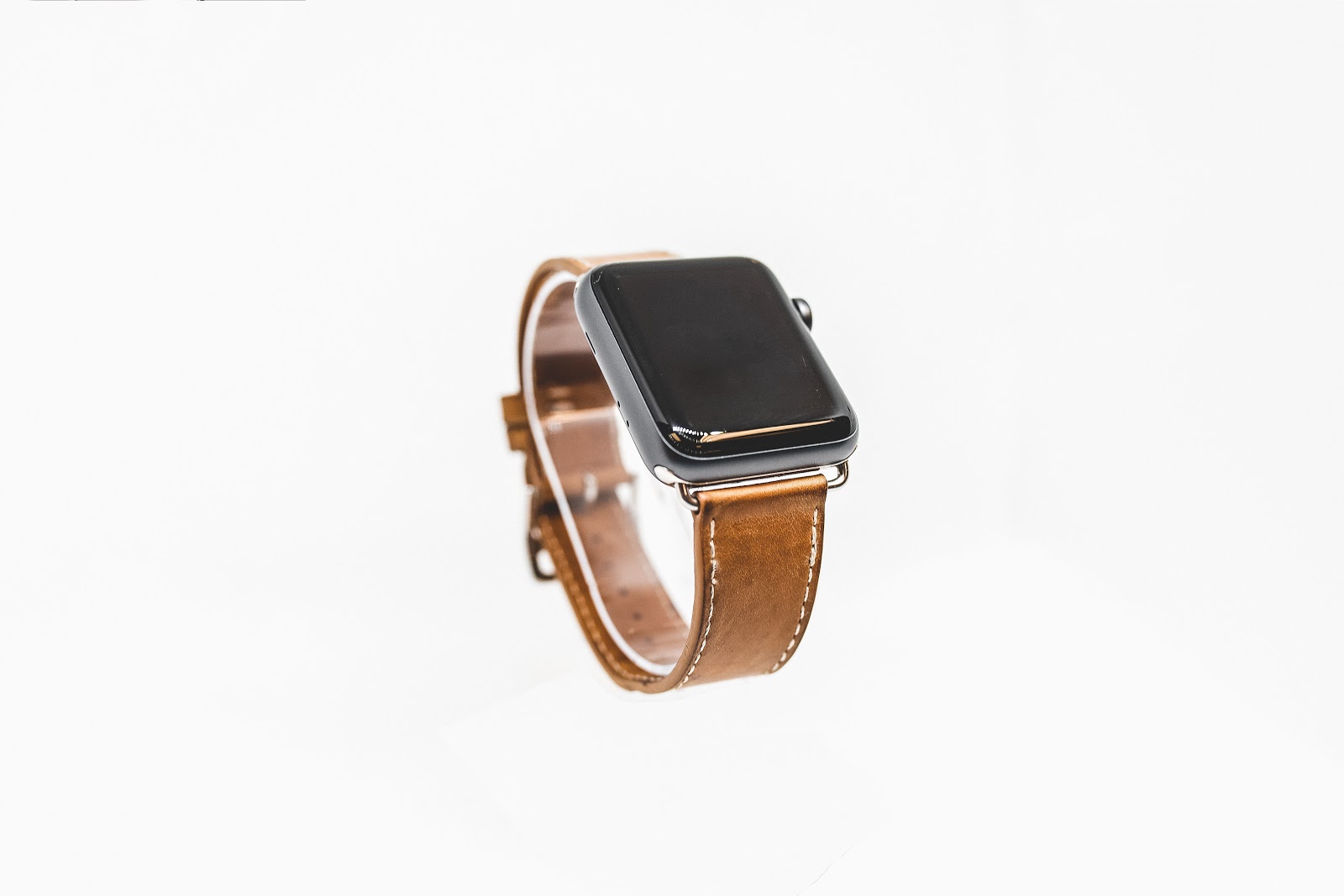 Smart Watch With a brown leather strap.