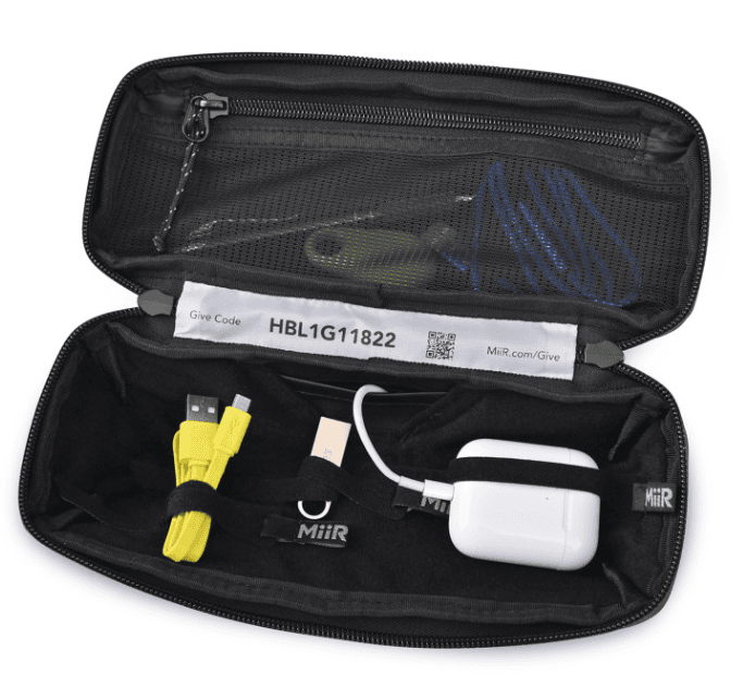 A black tech organizer with tech accessories inside.