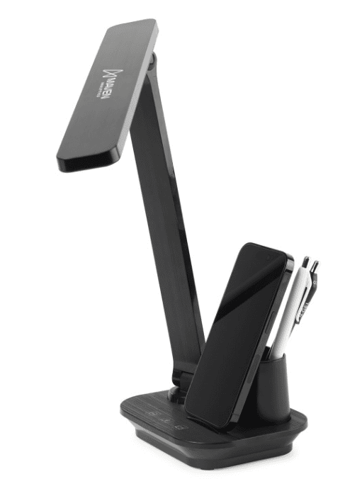 A desk lamp with a phone and two pens on it.