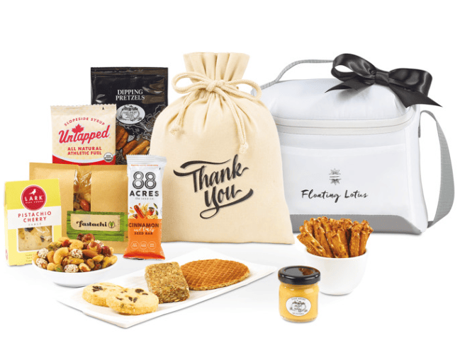 A cooler bag and a pouch surrounded by sweet and salty treats.