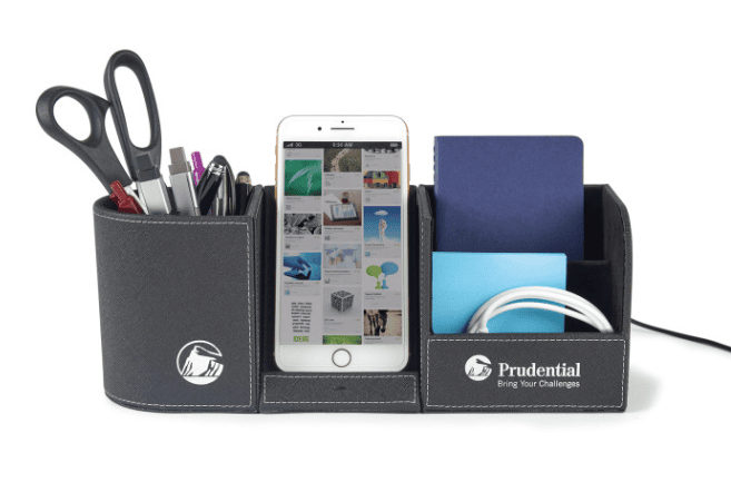 A desk organizer with pens, scissors, sticky notes, and a phone inside.