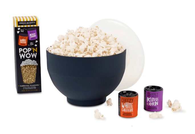 A bowl of popcorn, a box of popcorn, and two small containers.