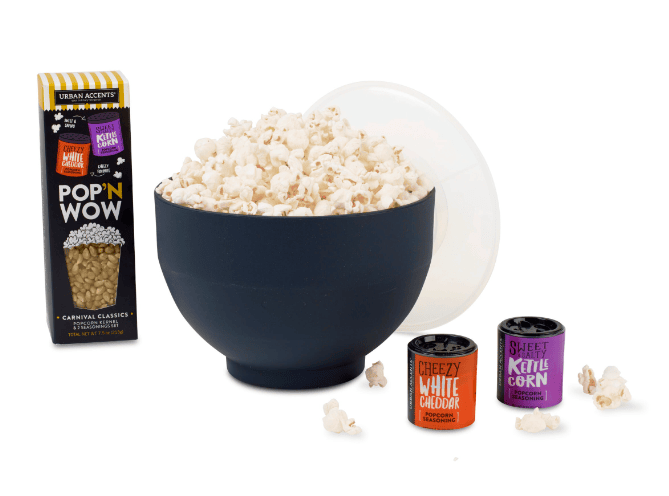 A bowl of popcorn, a popcorn package and two containers.