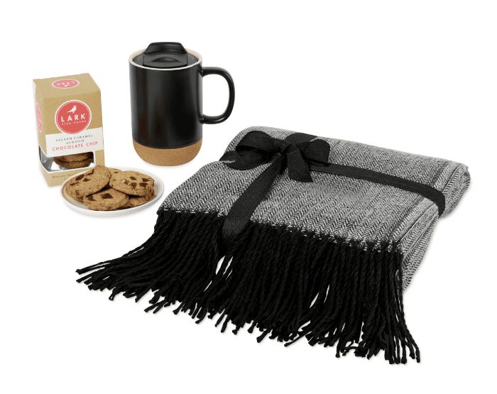 SwagDrop All Wrapped Up Gift Set, including a comfy blanket, a sleek mug, and delicious cookies for a cozy night at home.
