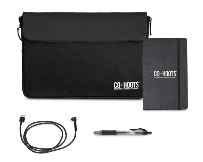 Screenshot of notebook, pen, charging cable and office sleeve.