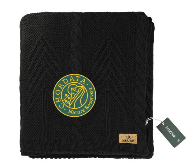 SwagDrop Tentree Organic Cotton Cable Blanket, in black, perfect for cozying up and supporting global reforestation efforts.